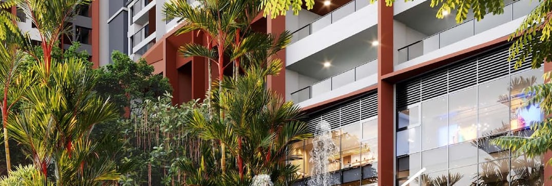 Courtyard water feature framed by palms against the SkySOLIS podium